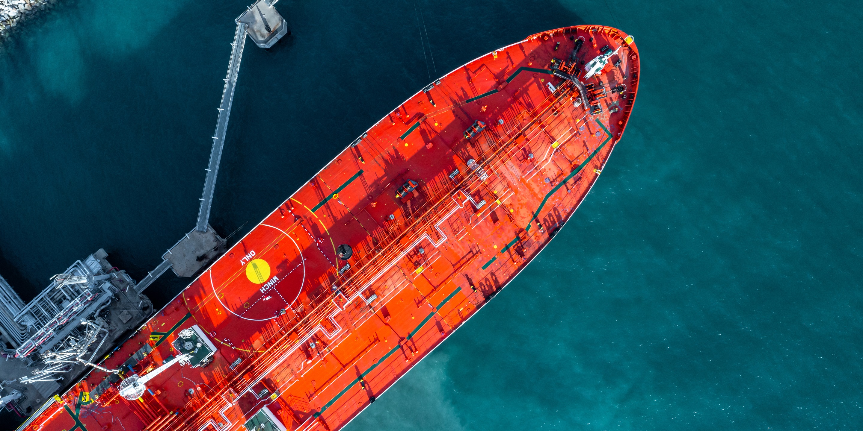 Aerial top view oil ship tanker vessel loading and unloading in oil terminal station refinery, Global business import export logistic transportayion sea freight cargo tanker, Red crude oil tanker ship at port.