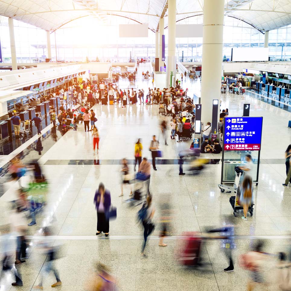 People walking through a busy airport
