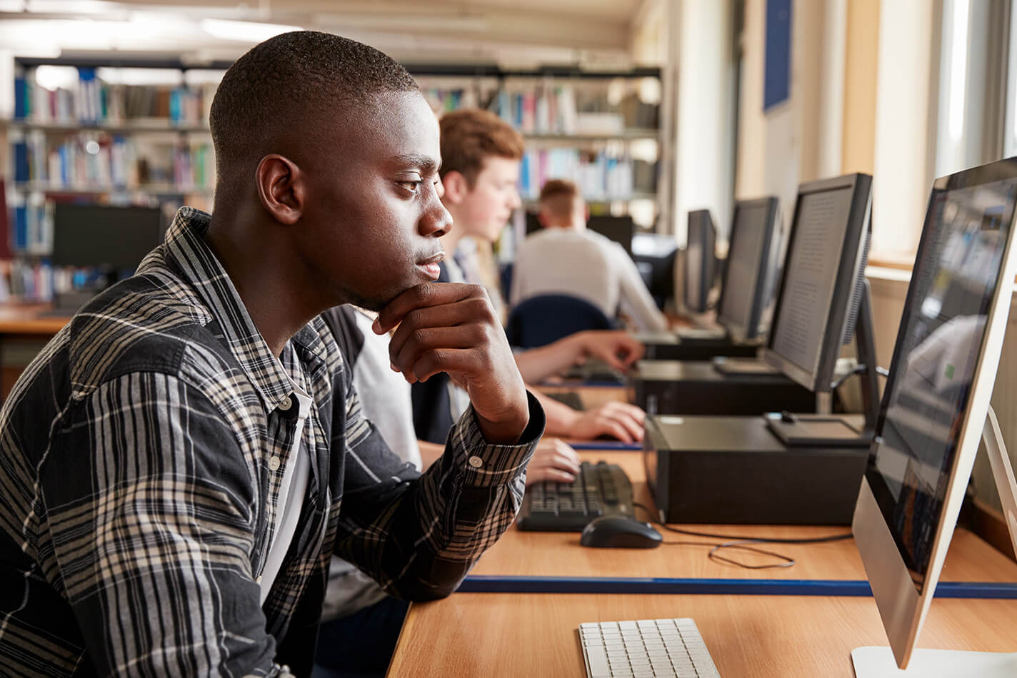 Young man at computer in class