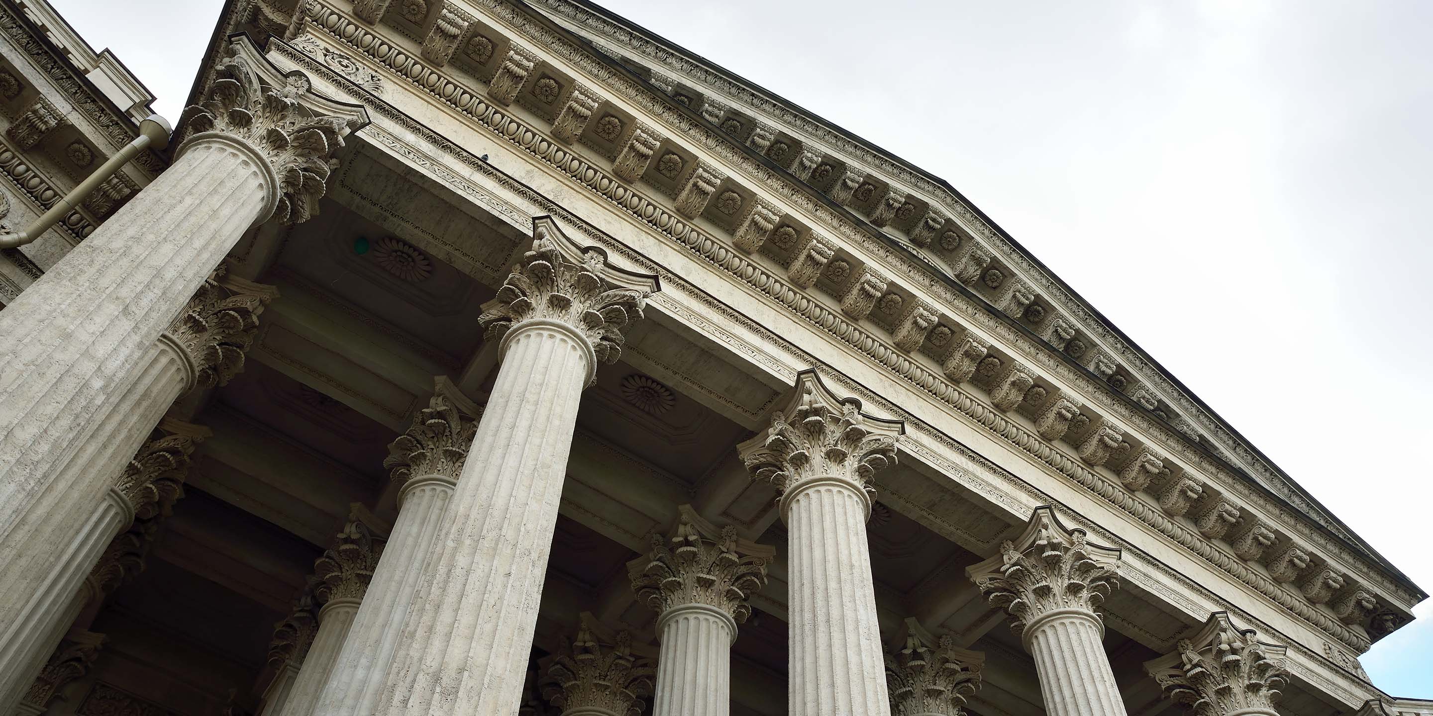 Intricate entablature rests atop tall, decorative Corinthian columns.