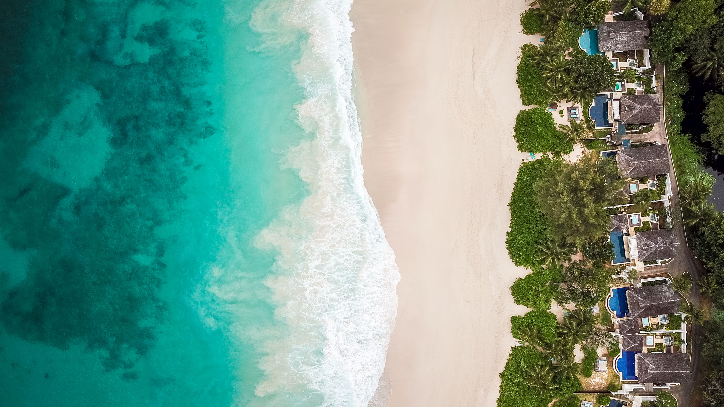 hon-aerial-tropical-resort-beach-villas-pools-1204422150.jpg