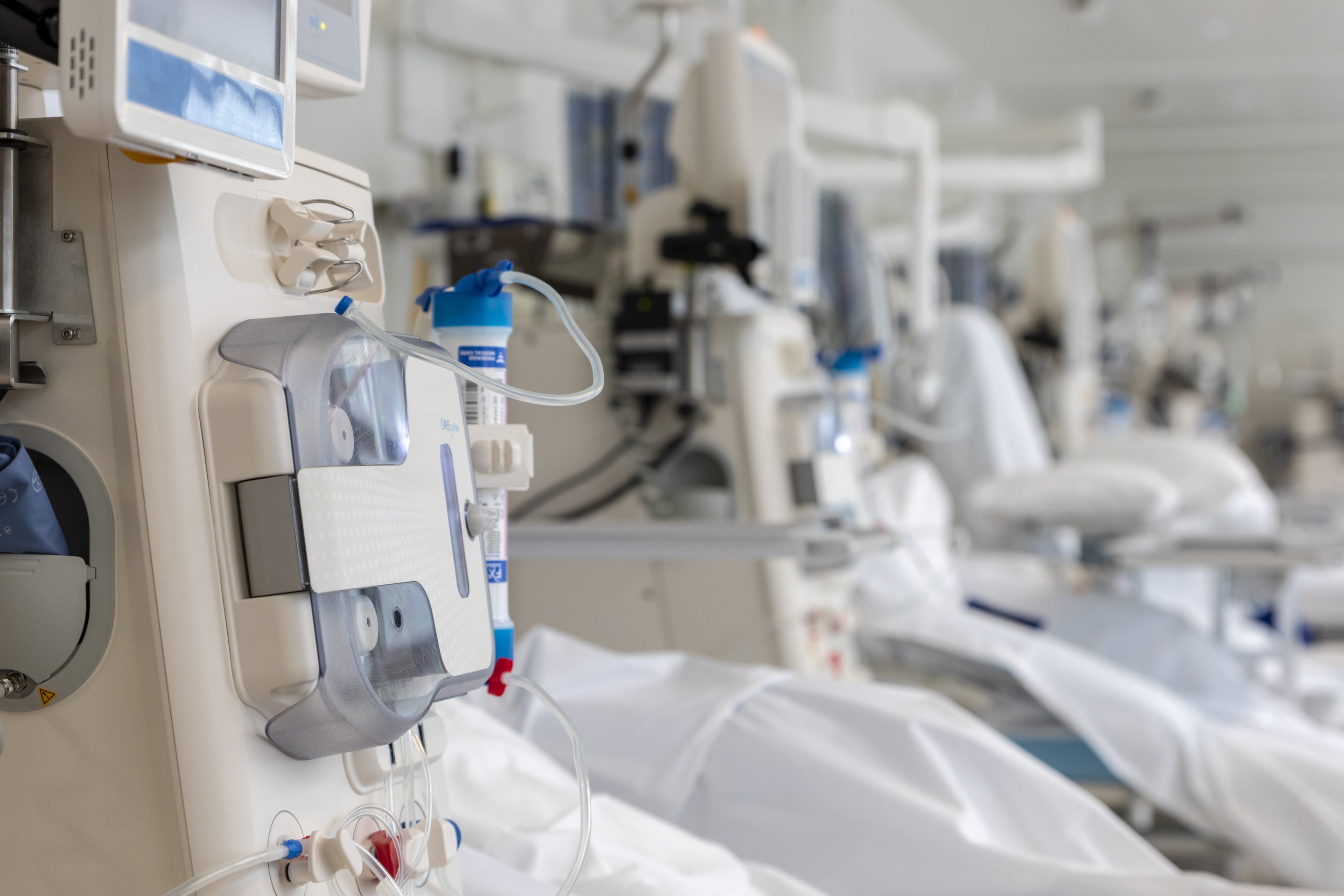 A close-up view of medical dialysis equipment lined up in a bright, modern clinical treatment room.