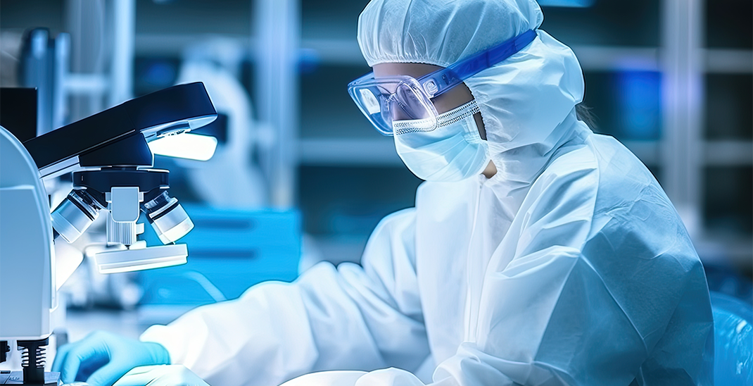 Researcher in a protective mask working in a laboratory of a research institute. Creation of innovative medicines and vaccines. Close-up photo.