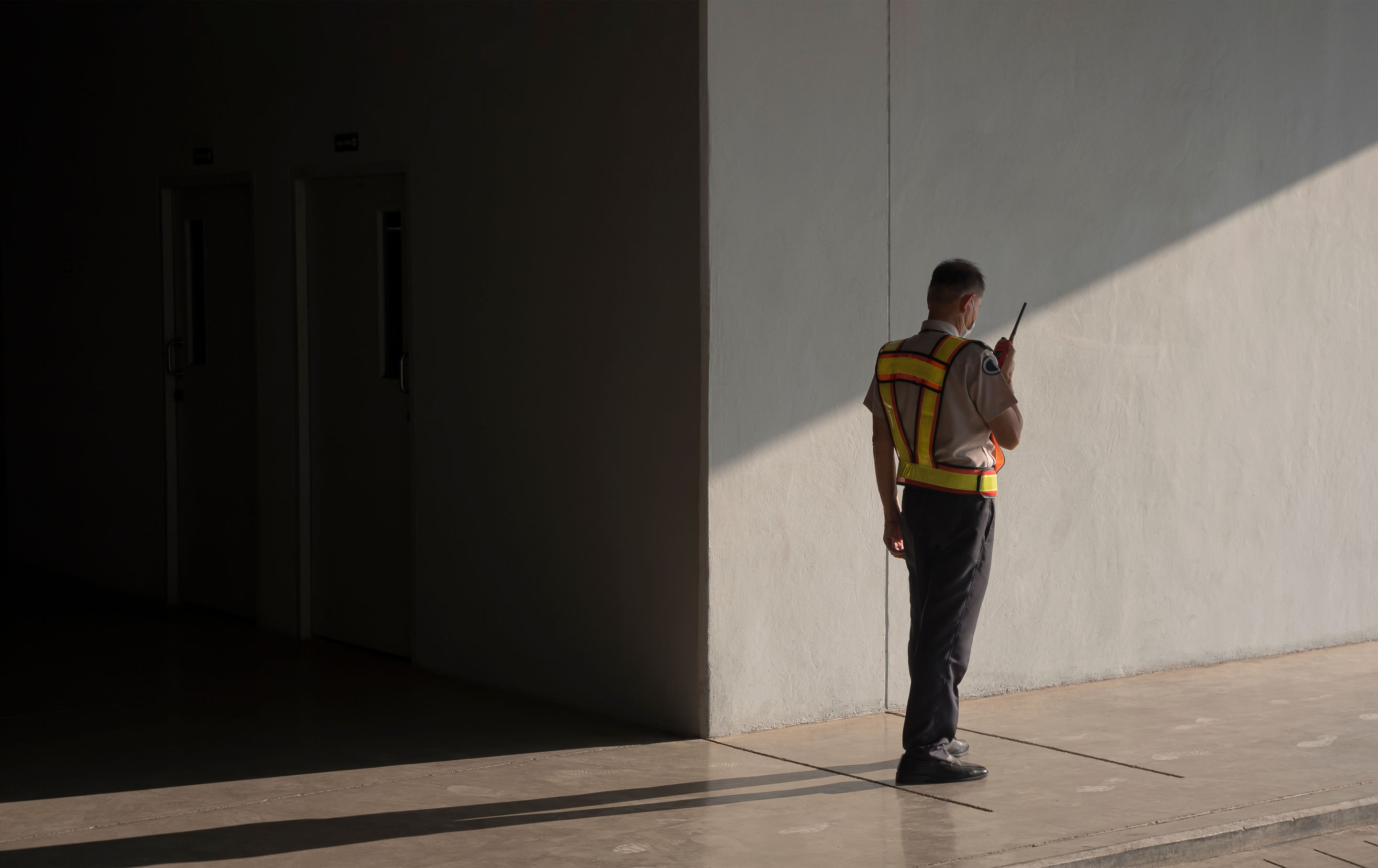 hon-security-guard-walkie-talkie-building-interior-459318067.jpg