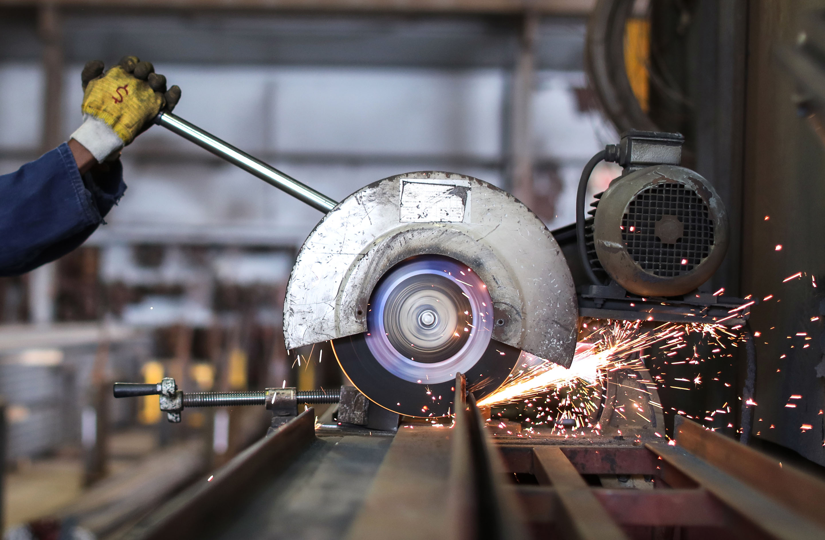 hon-worker-operating-abrasive-cutoff-saw-sparks-1213464862.jpg