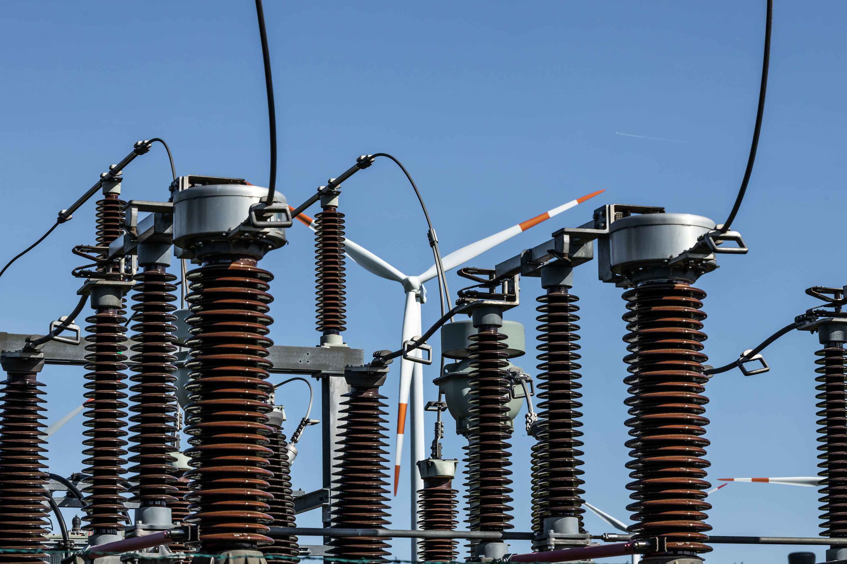 hon-electrical-substation-insulators-wind-turbine-background-1407576476.jpg