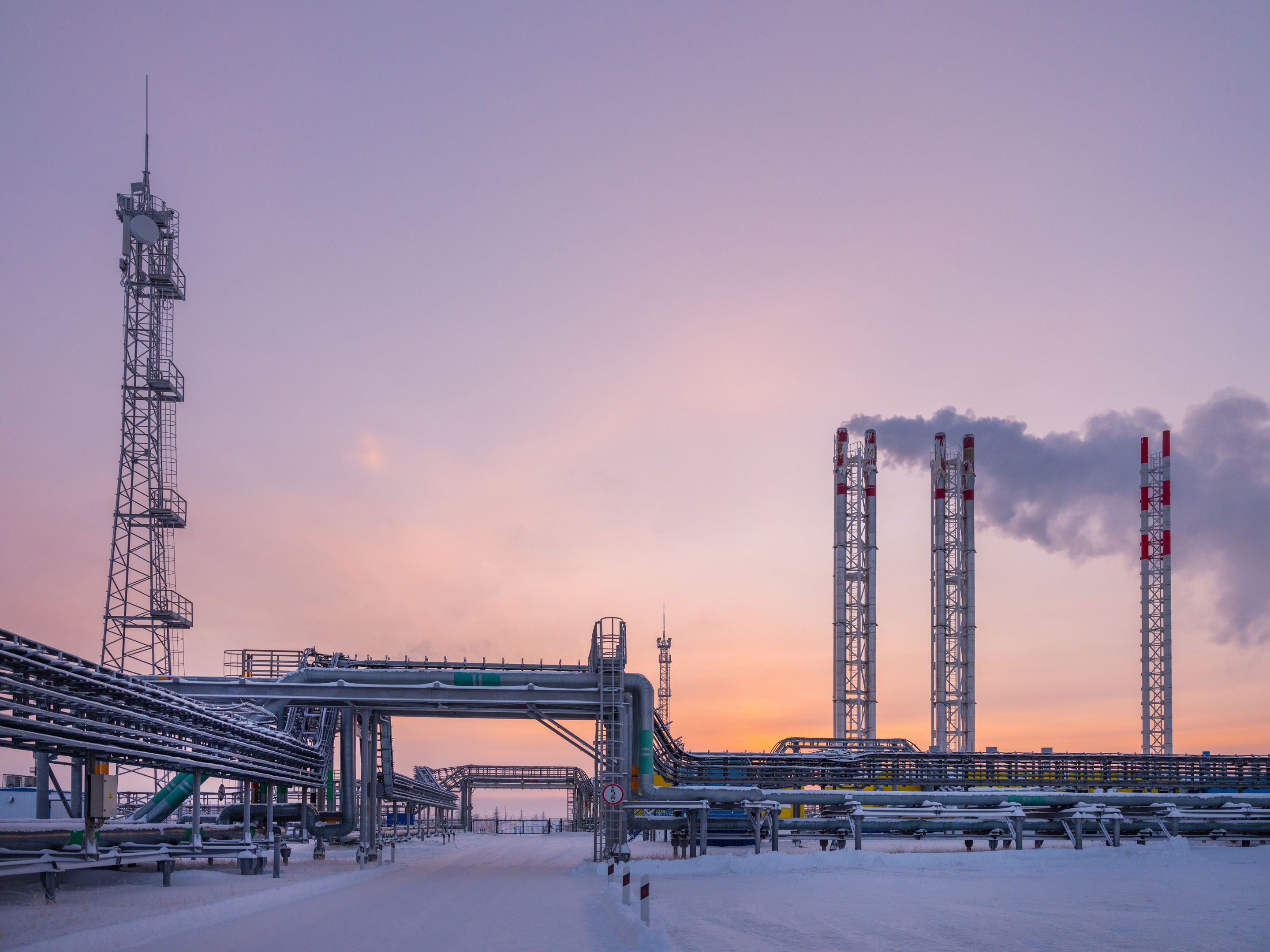 hon-snowy-oil-gas-facility-flare-stacks-sunset-1224591220.jpg
