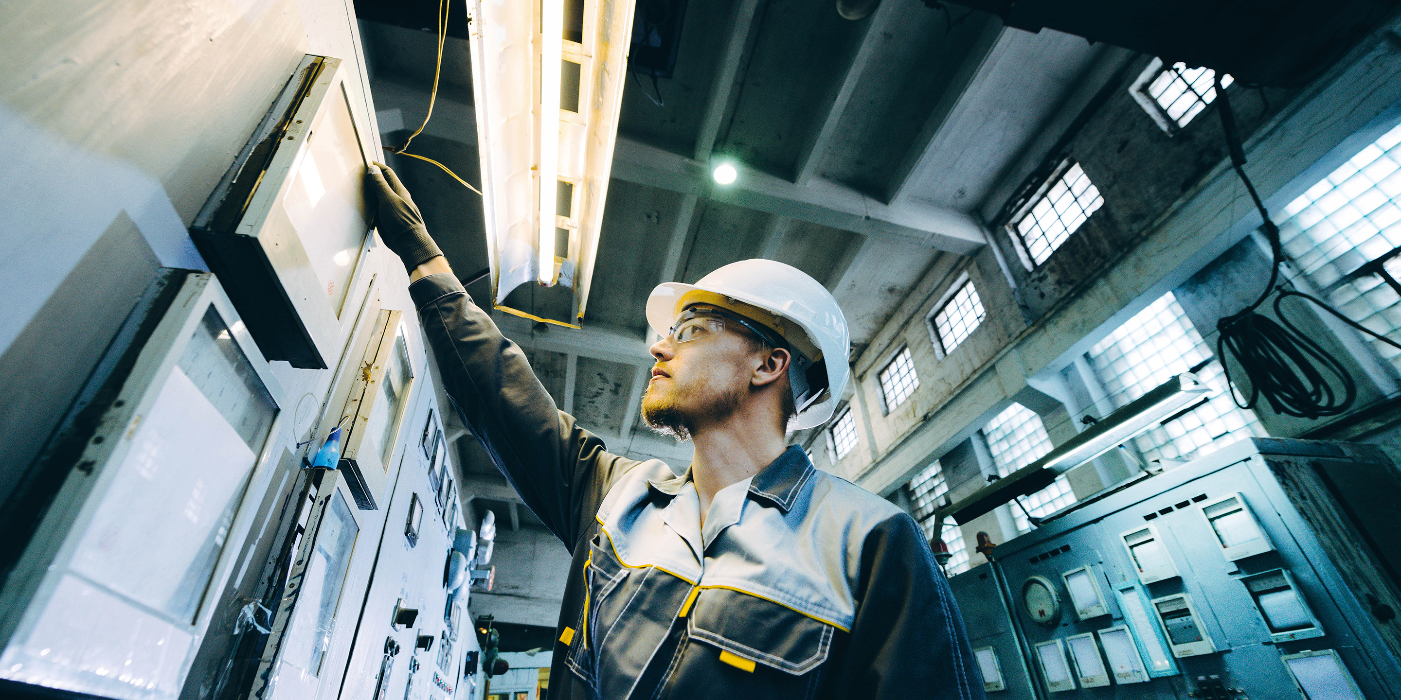 Industrial Technician working on the Control Panel to adjust the settings required.