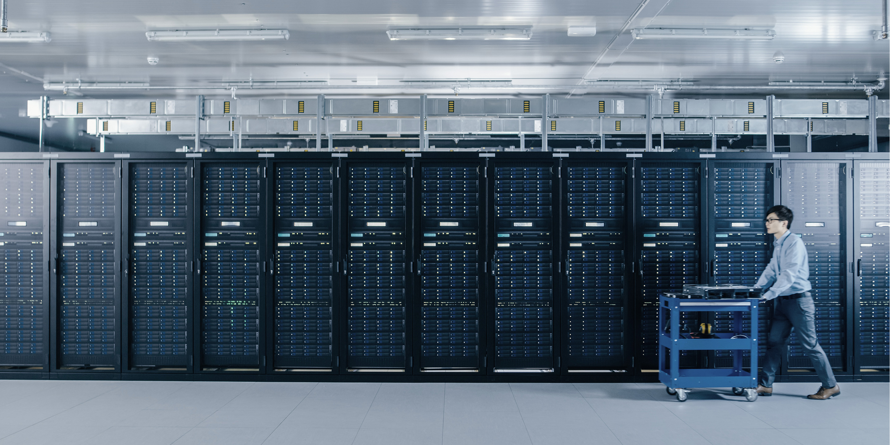 Modern Data Center: IT Technician Working with Server Racks