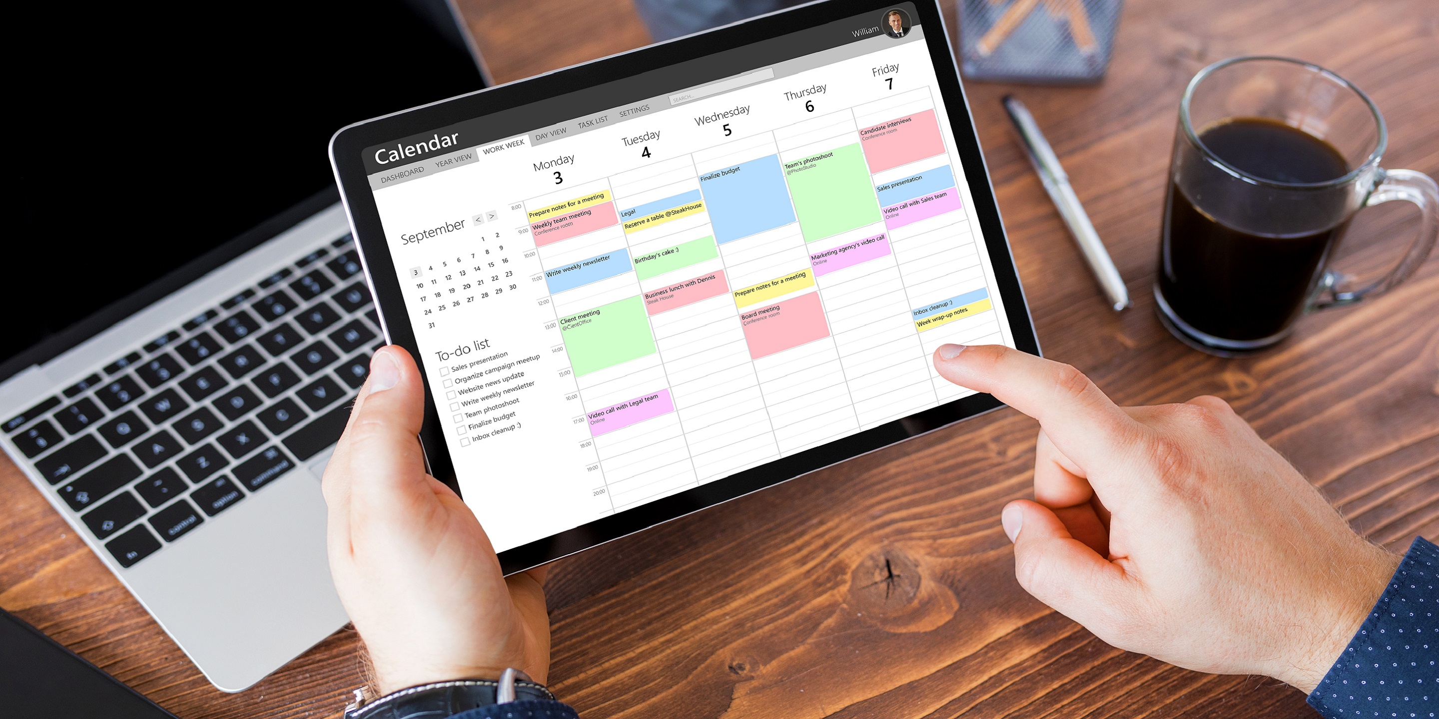 Man using calendar app on tablet in office