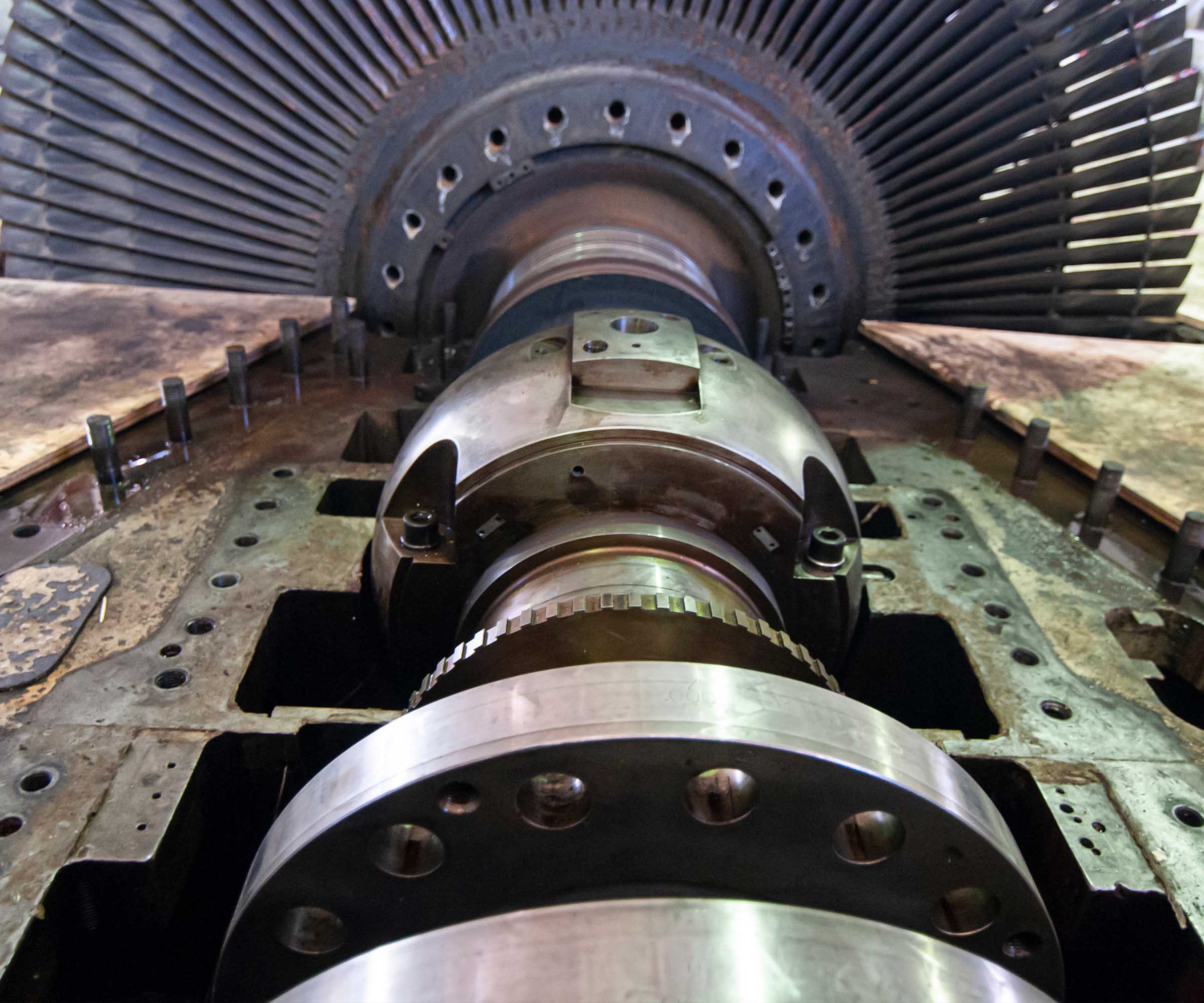 A technician in safety gear operates machinery in a modern electrical facility, ensuring optimal performance and safety.